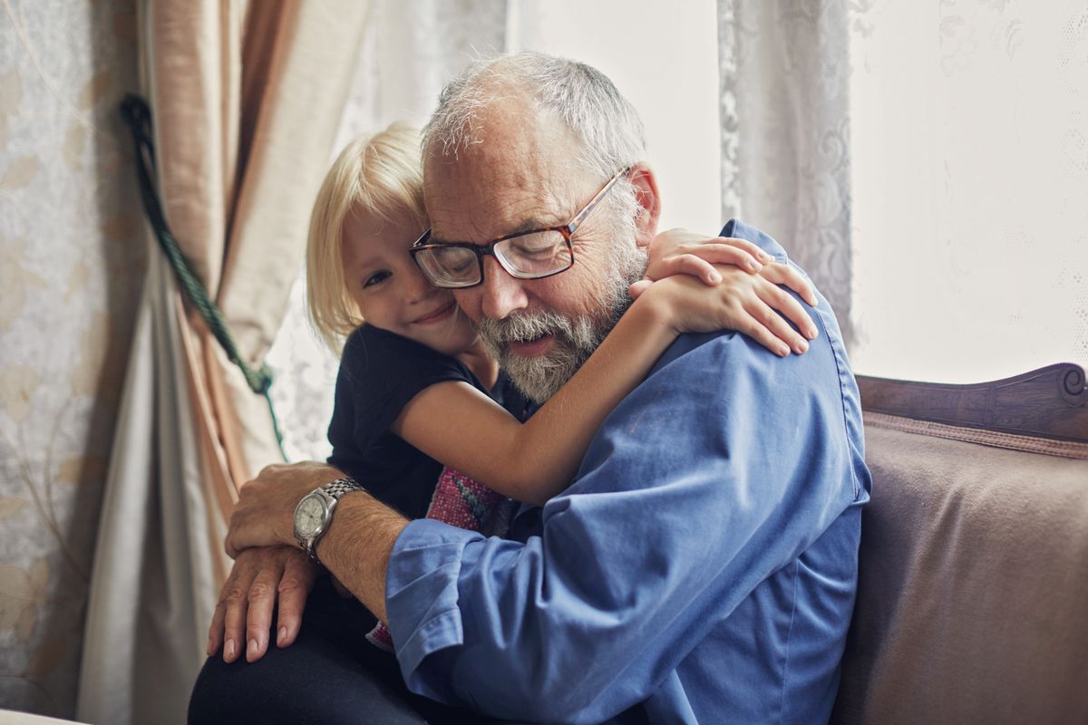 Little girl giving her Grandfather a hug